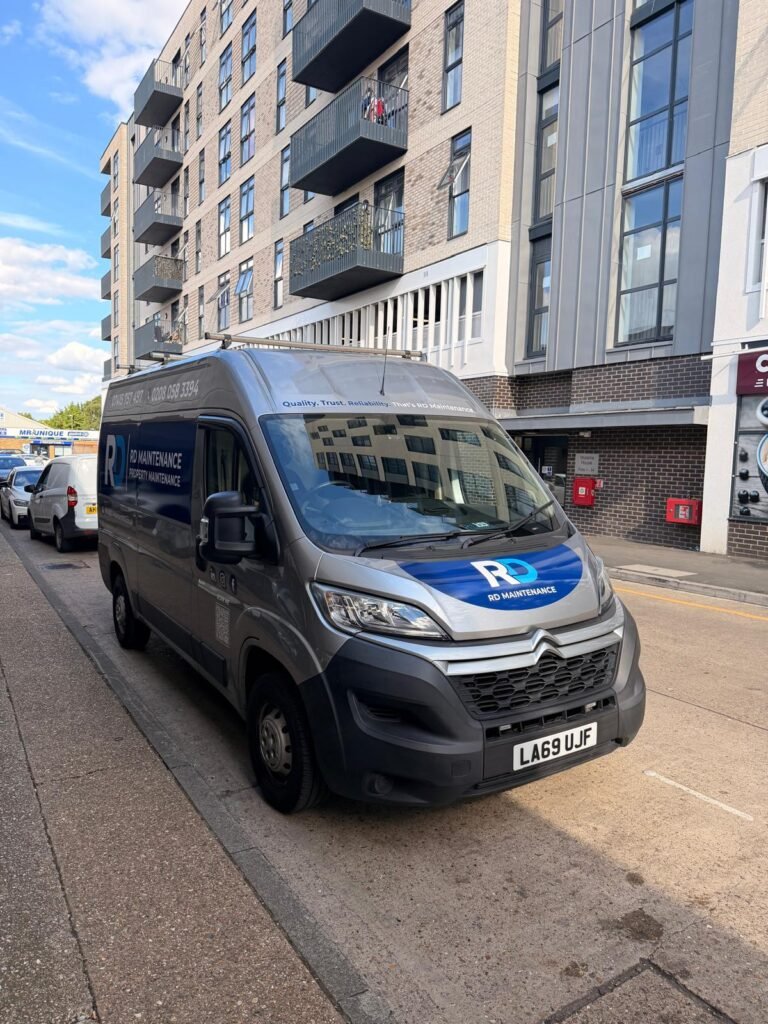 RD Maintenance van parked outside a modern residential block