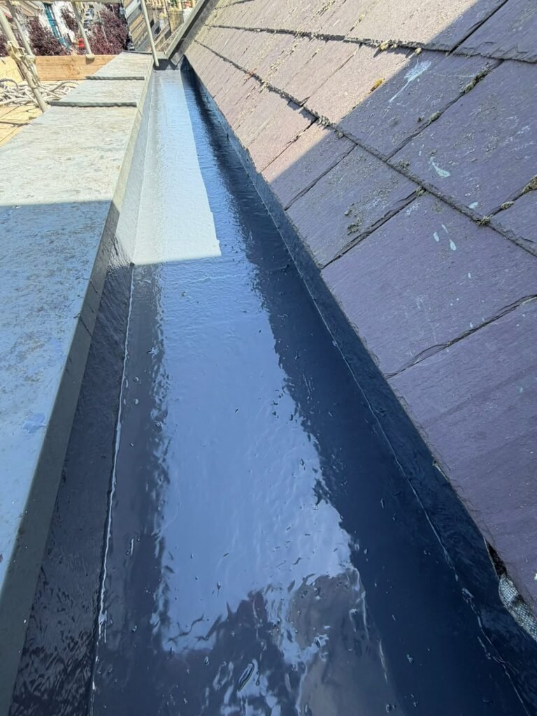 Newly lined roof valley on a tiled roof