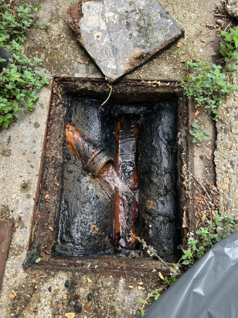 Open drainage inspection chamber showing pipework