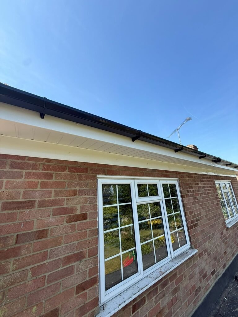 New white fascias and soffits fitted to a brick building