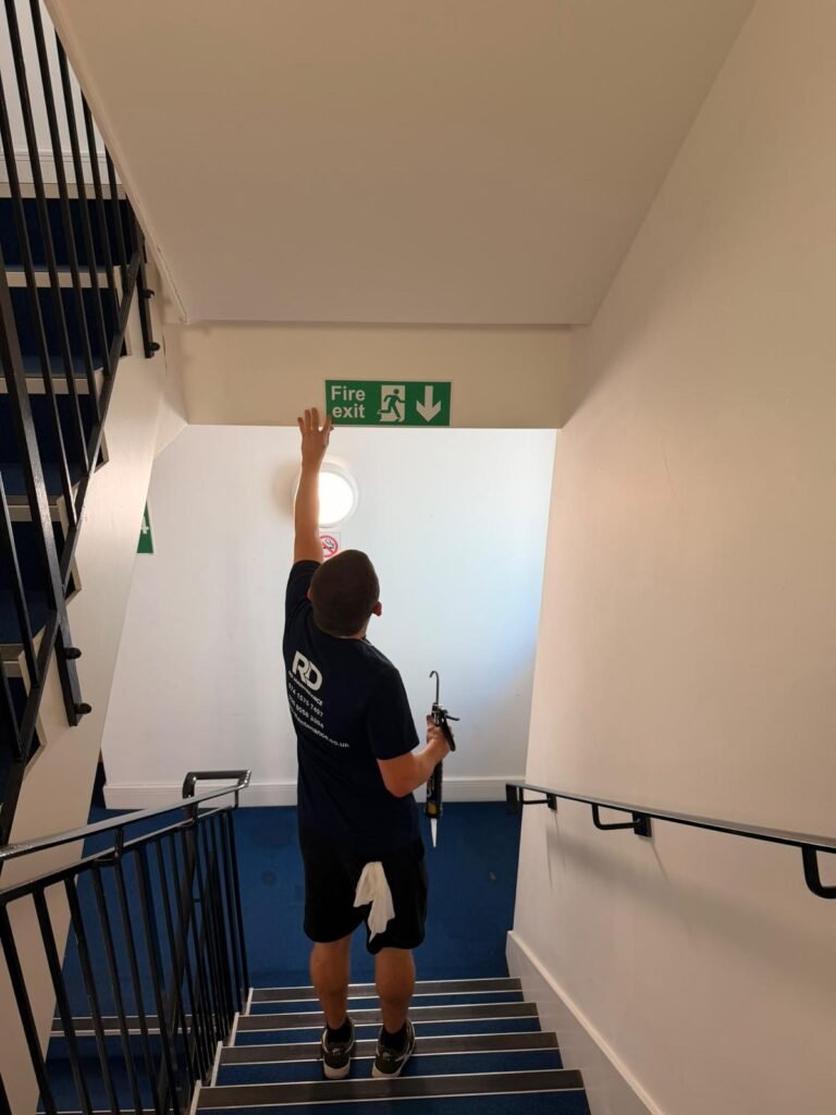 RD Maintenance team member carrying out block maintenance in a communal stairwell